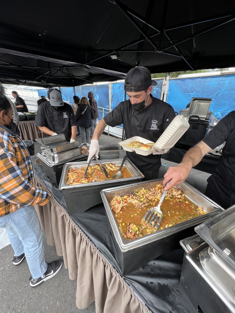 Catering team serving hot meals on a film set buffet line